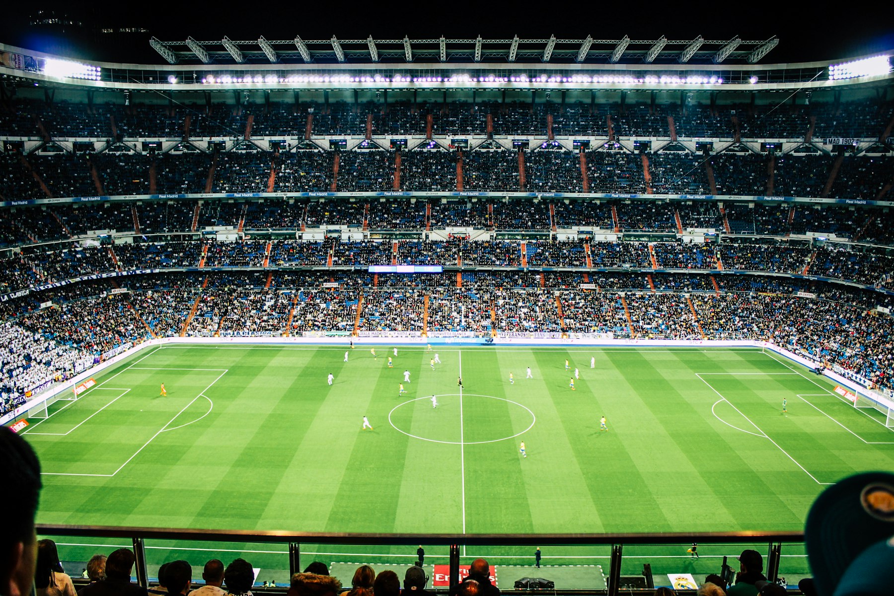 Packed night stadium during a live sports broadcast.
